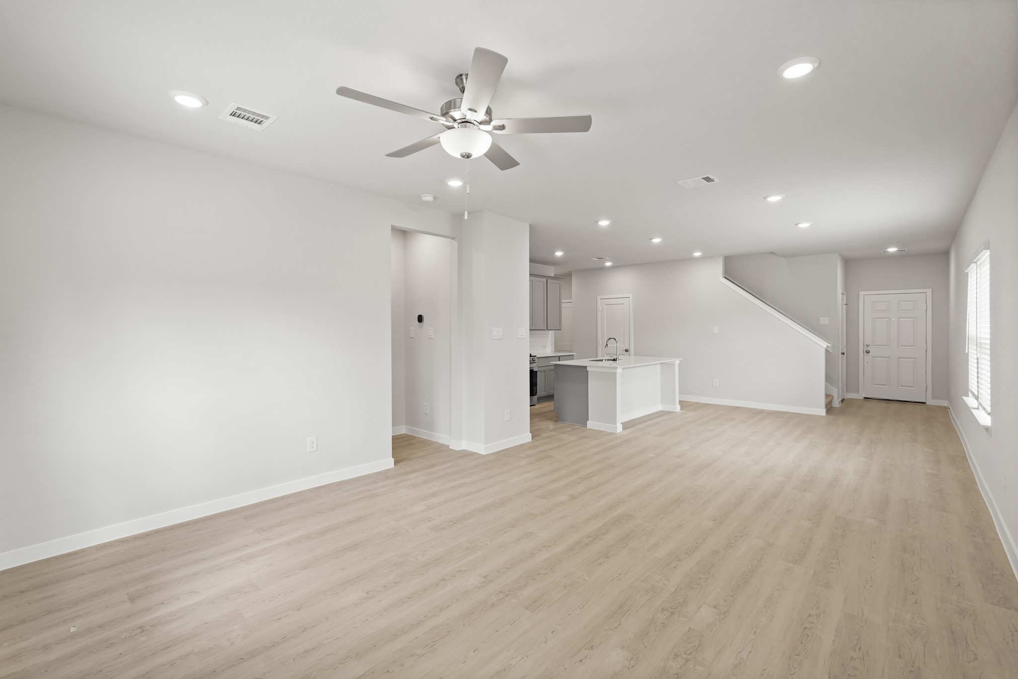 217 Spring Drive Hockley, TX 77447 - Photo 8 of 27 a view of an empty room with wooden floor and ceiling fan