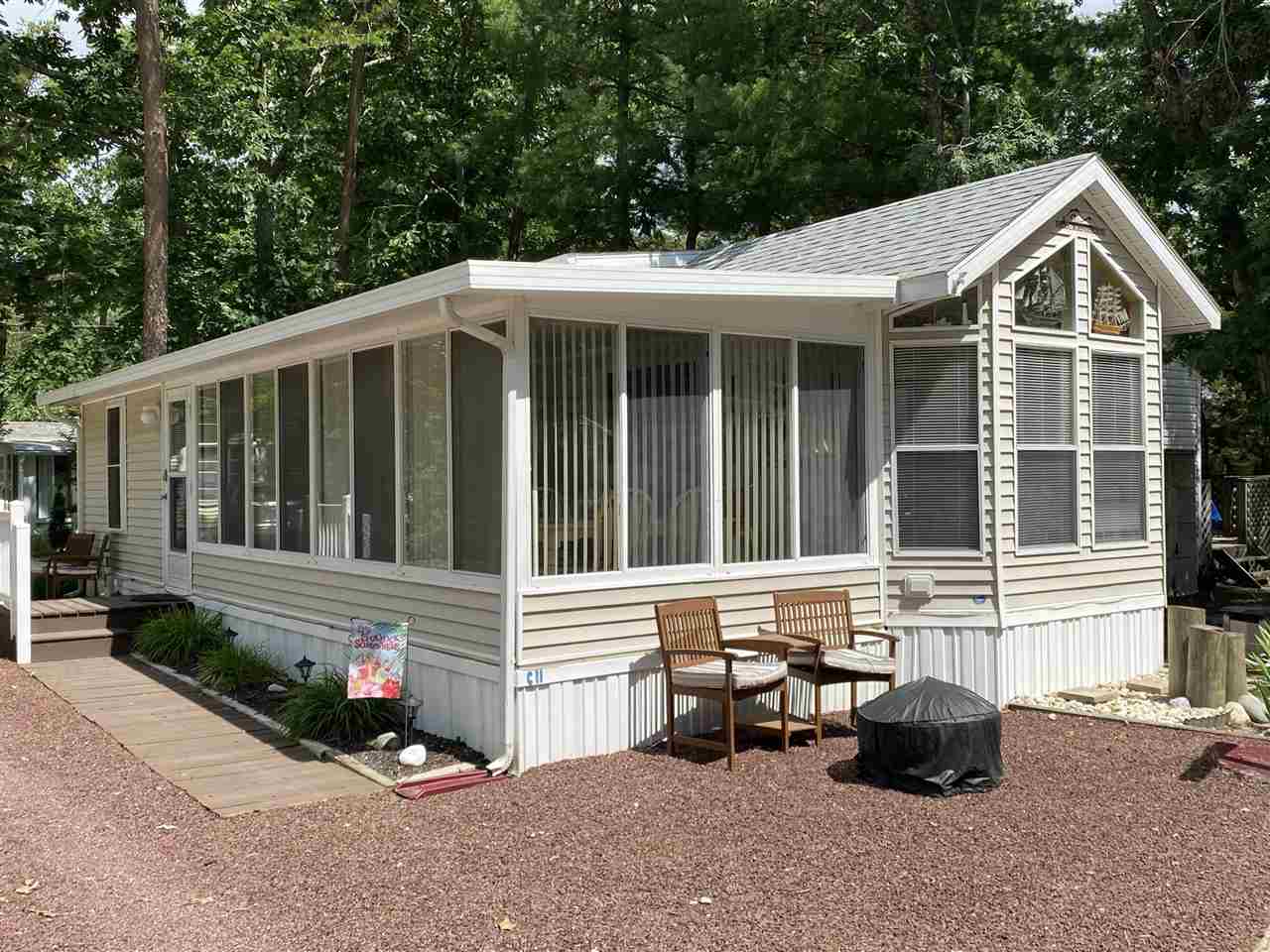 a front view of a house with a garden and porch