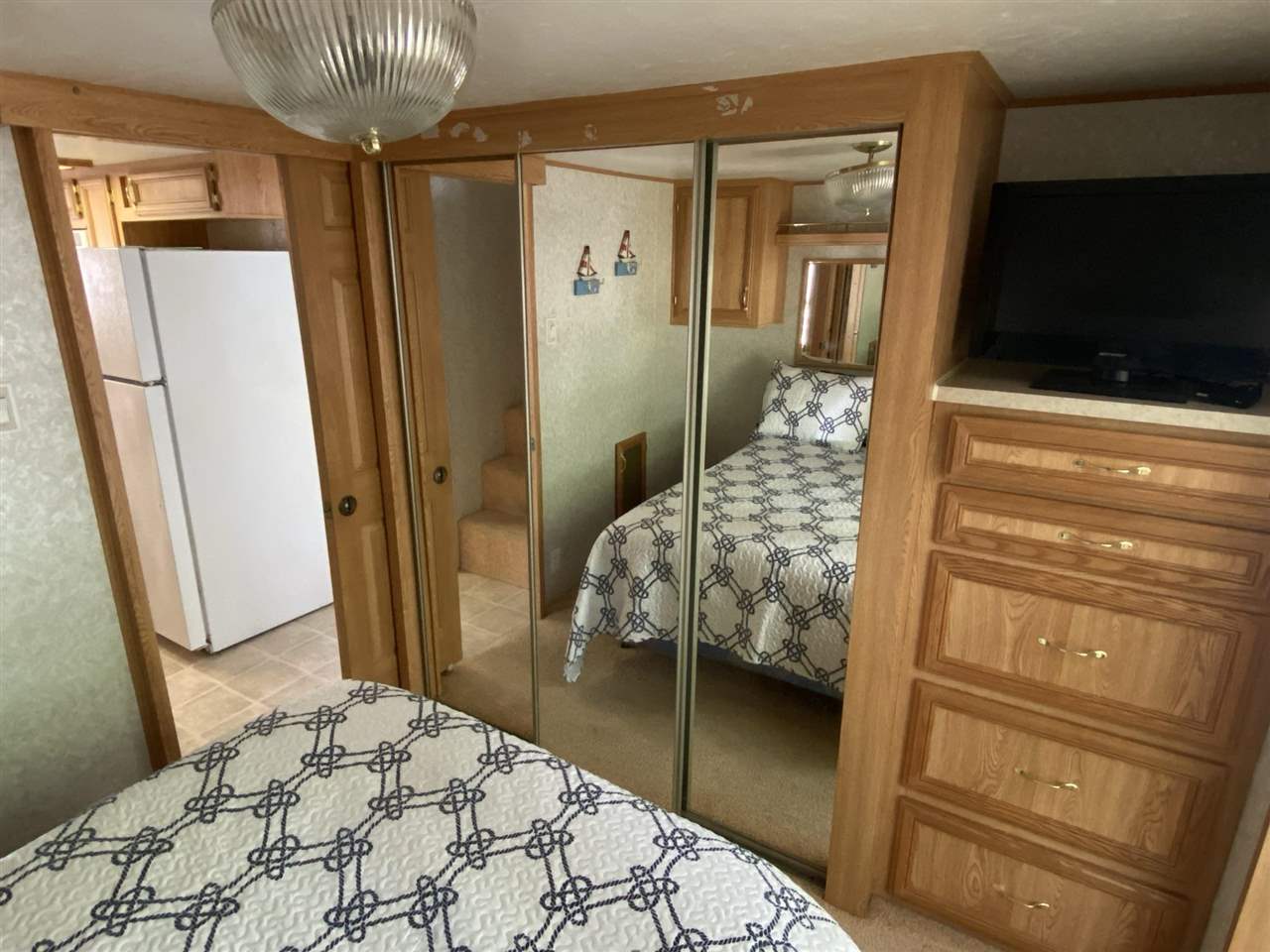 516 Highway 9 Marmora, NJ 08223 - Photo 16 of 28 a bedroom with a bed and a flat tv screen on the dresser