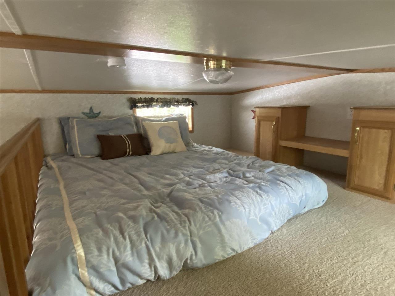 516 Highway 9 Marmora, NJ 08223 - Photo 26 of 28 a large bed sitting in a room next to a lamp