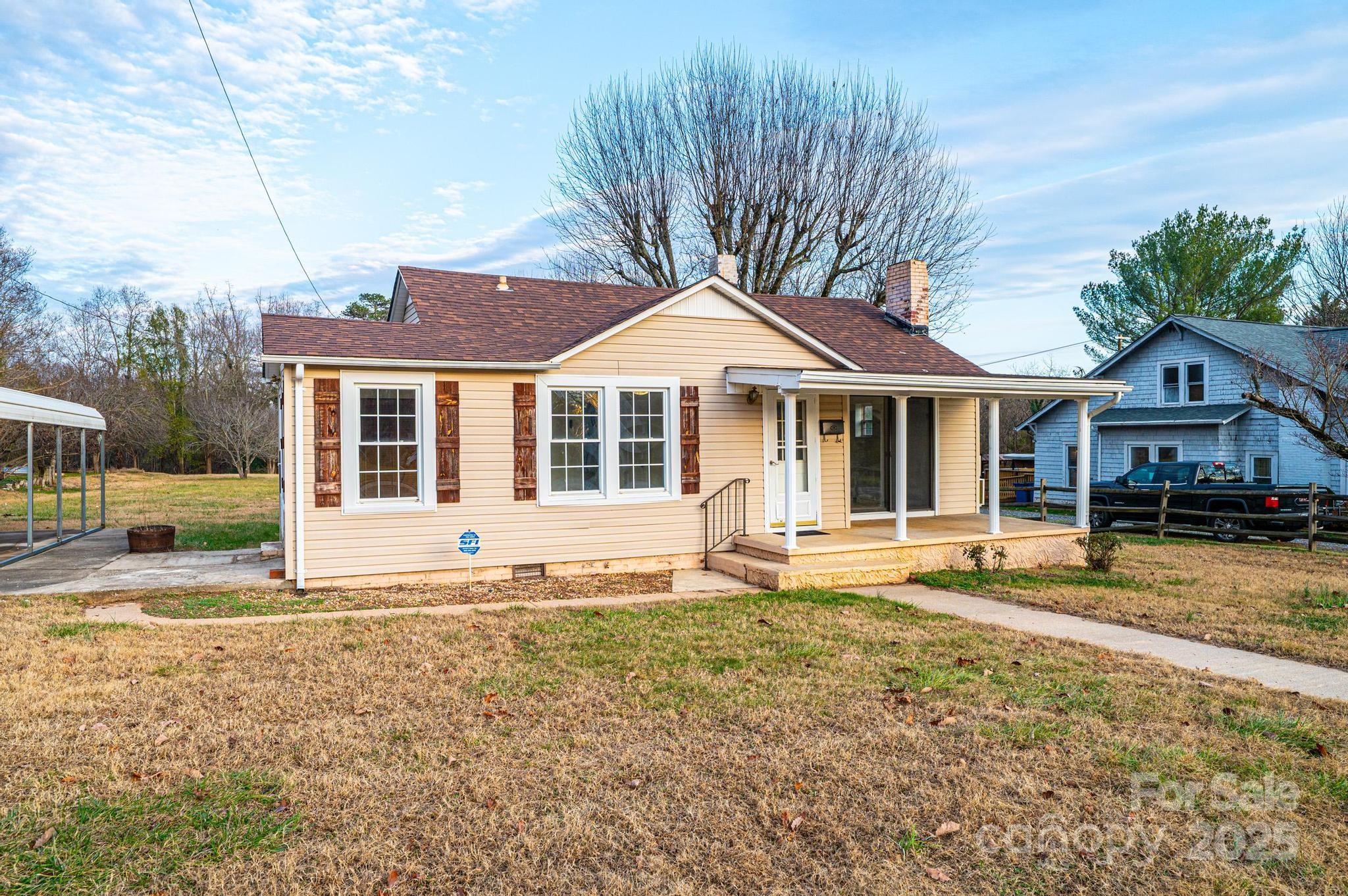 a front view of a house with a yard table and chairs