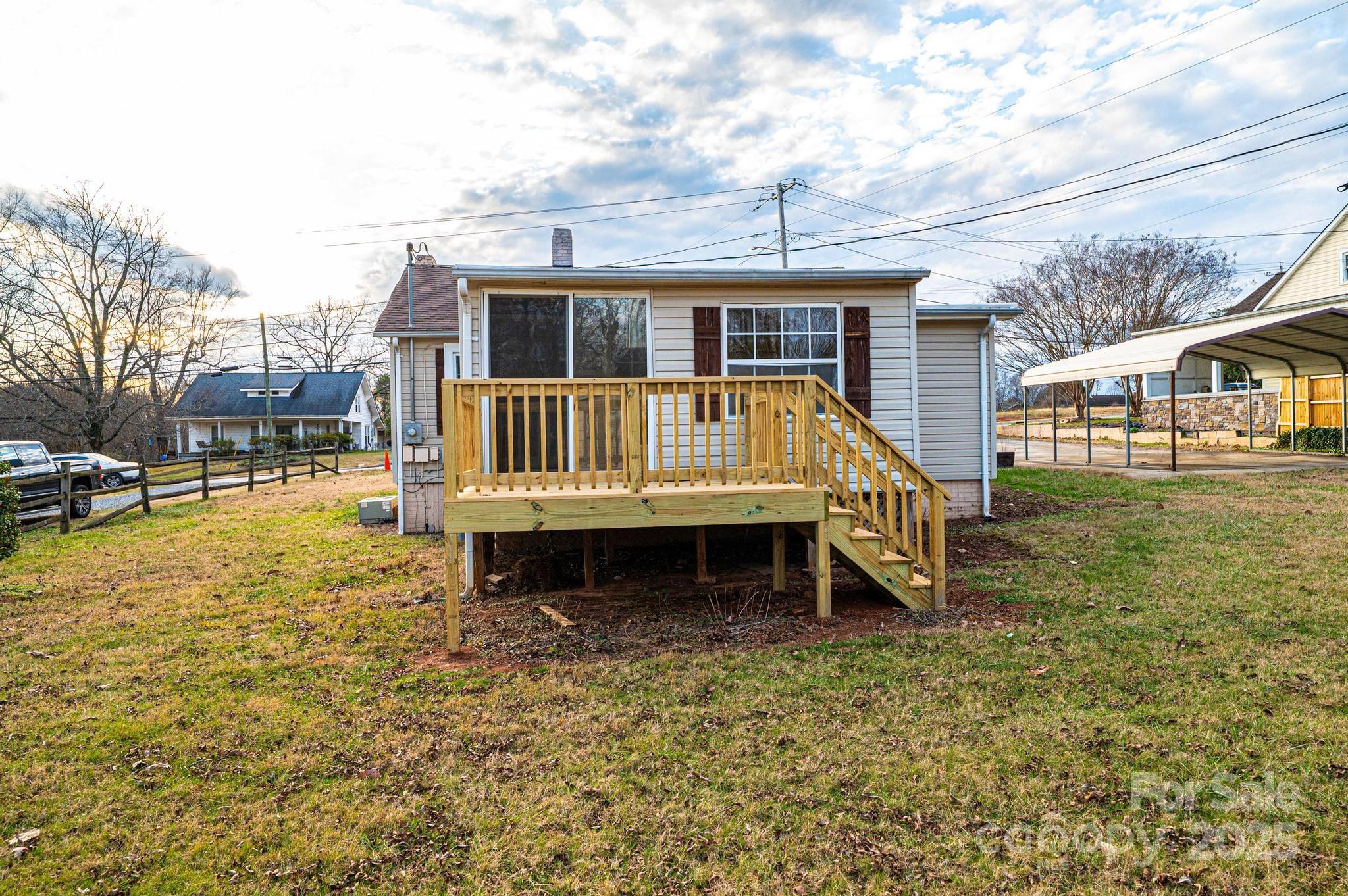 80 Duke Street Granite Falls, NC 28630 - Photo 16 of 48 a view of a house with backyard and deck
