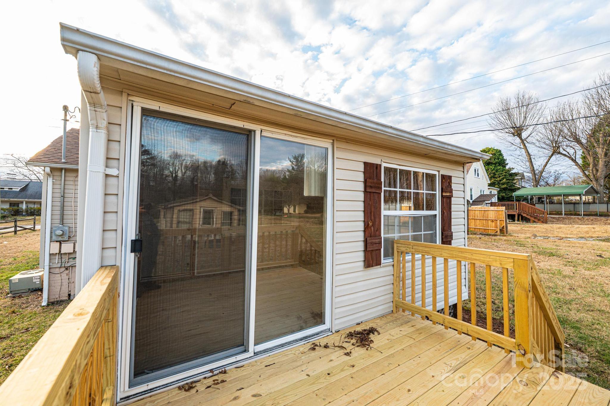 80 Duke Street Granite Falls, NC 28630 - Photo 21 of 48 a view of a balcony with a floor to ceiling window next to a yard