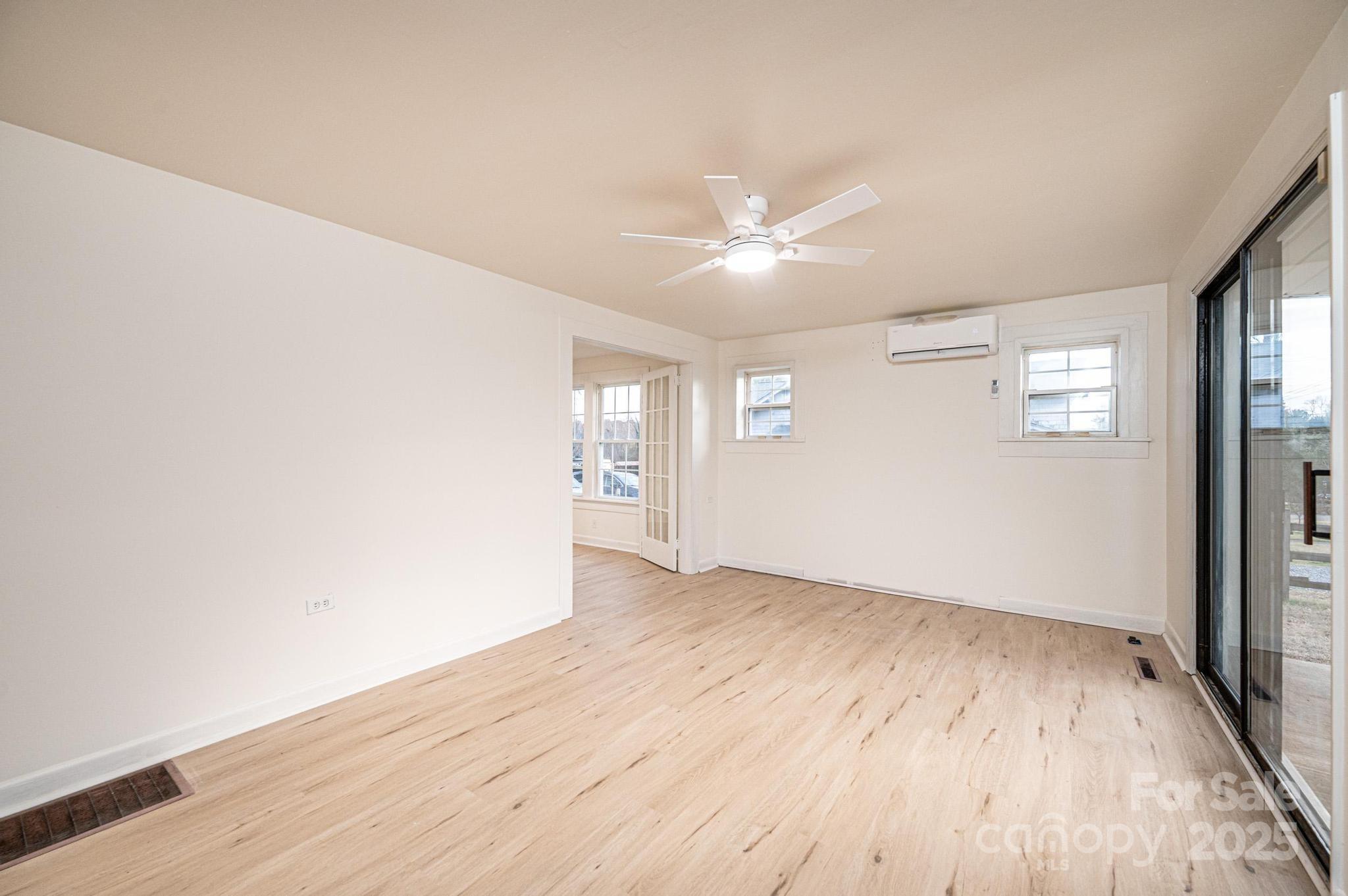 80 Duke Street Granite Falls, NC 28630 - Photo 24 of 48 an empty room with wooden floor and windows
