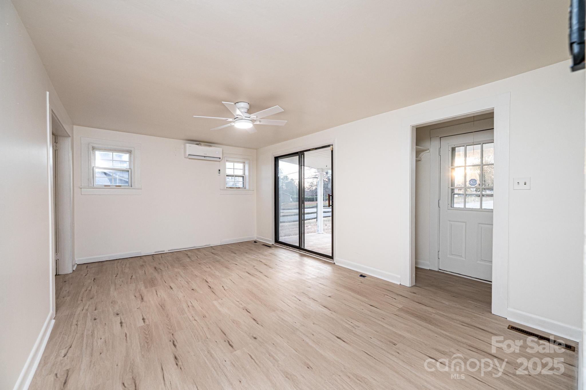 80 Duke Street Granite Falls, NC 28630 - Photo 25 of 48 an empty room with wooden floor and windows
