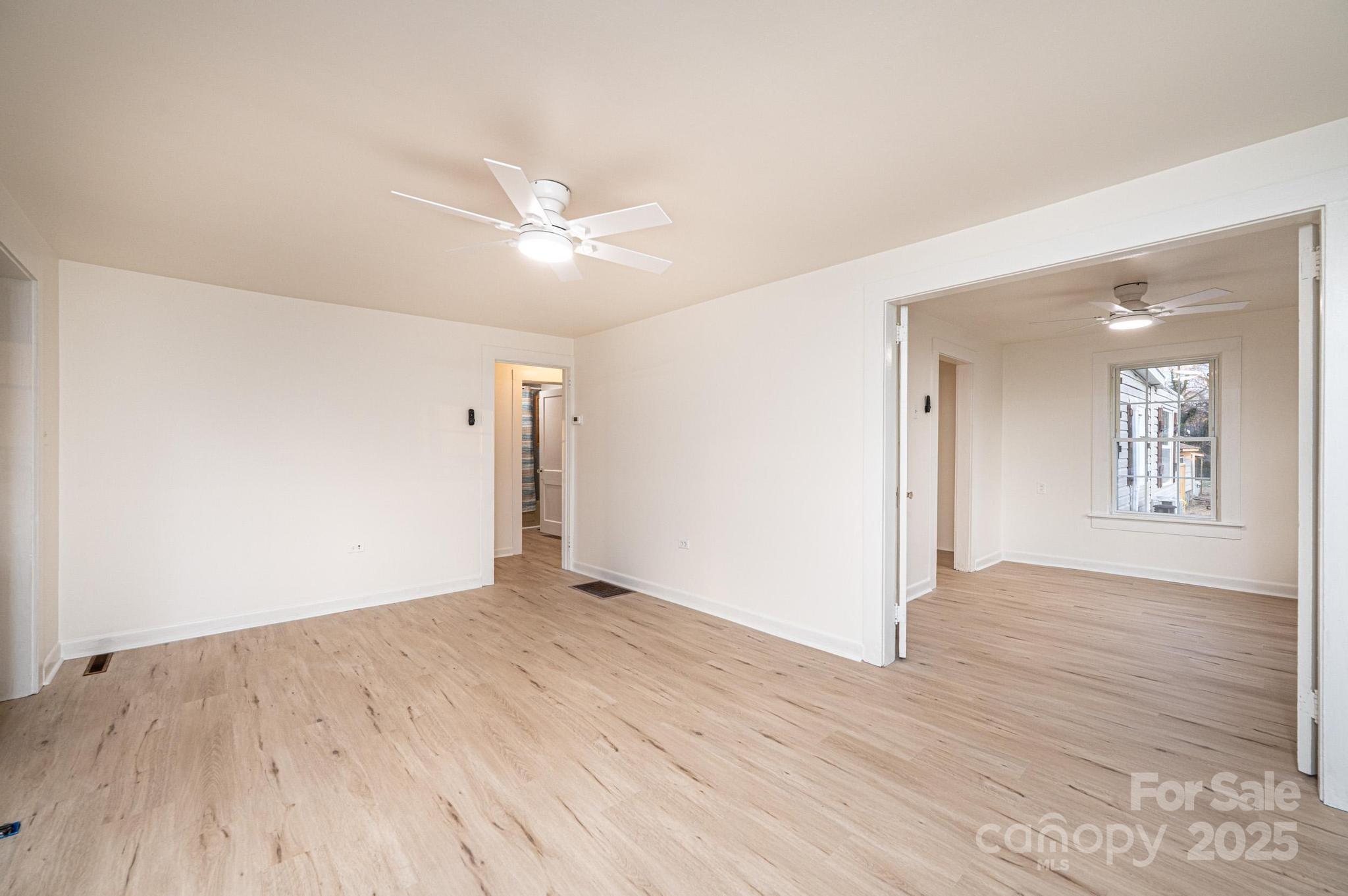 80 Duke Street Granite Falls, NC 28630 - Photo 26 of 48 an empty room with wooden floor and windows