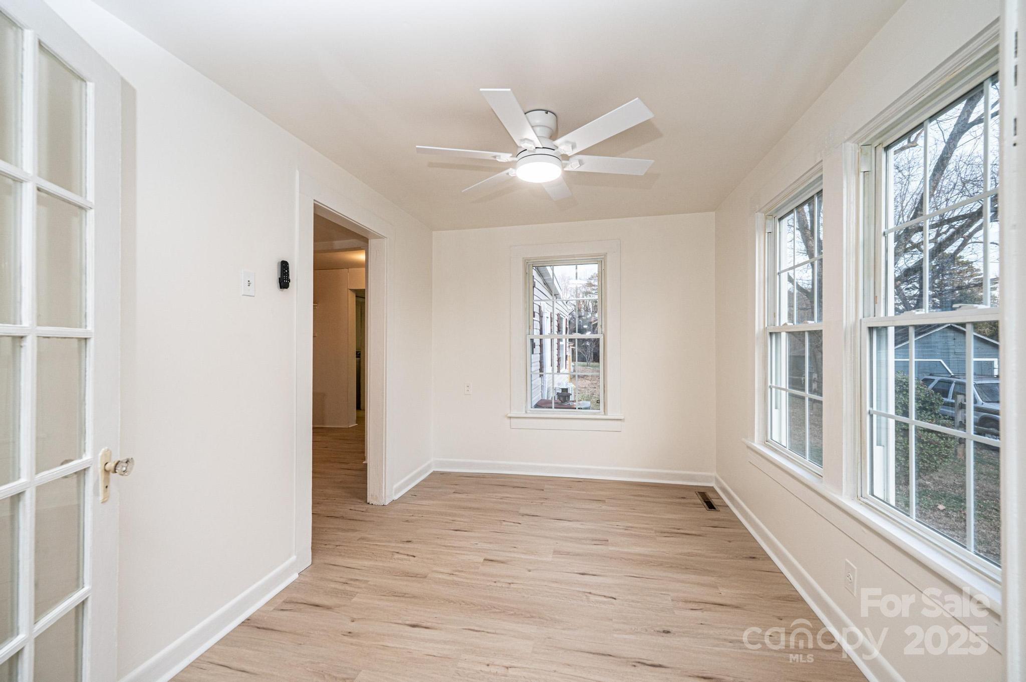 80 Duke Street Granite Falls, NC 28630 - Photo 27 of 48 a view of an empty room with a window and wooden floor