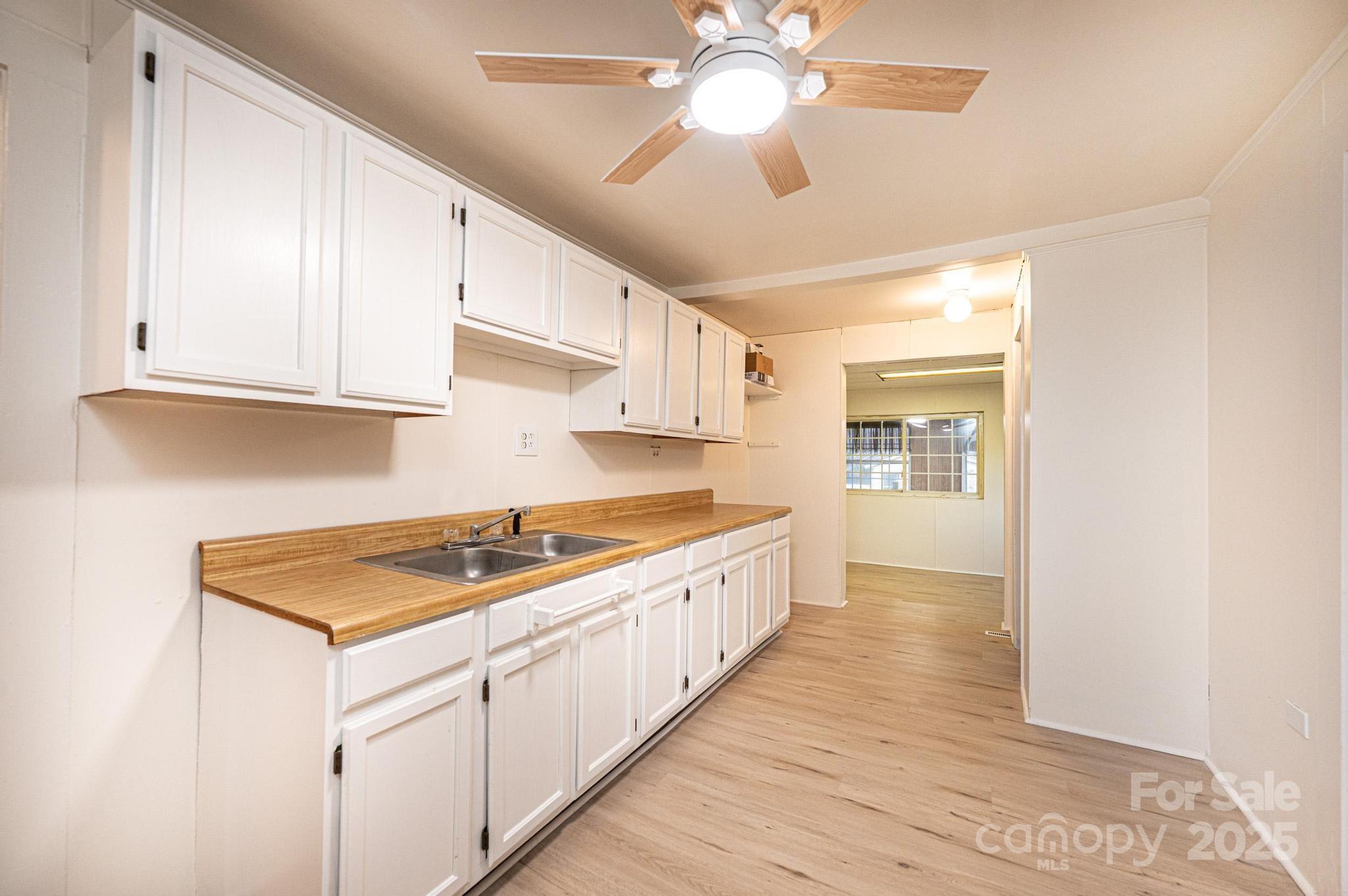 80 Duke Street Granite Falls, NC 28630 - Photo 31 of 48 a kitchen with stainless steel appliances granite countertop a sink and cabinets