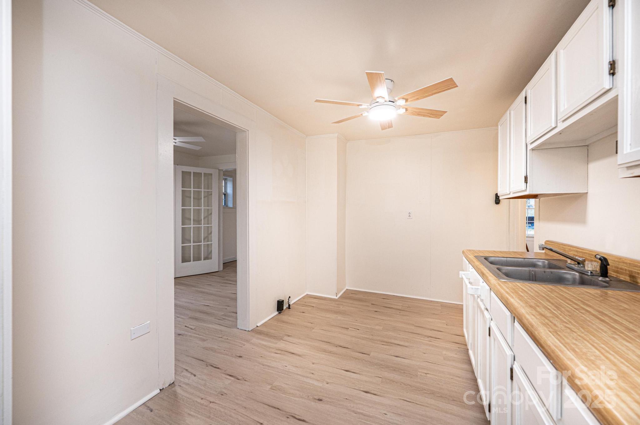 80 Duke Street Granite Falls, NC 28630 - Photo 34 of 48 a kitchen with a sink cabinets and wooden floor