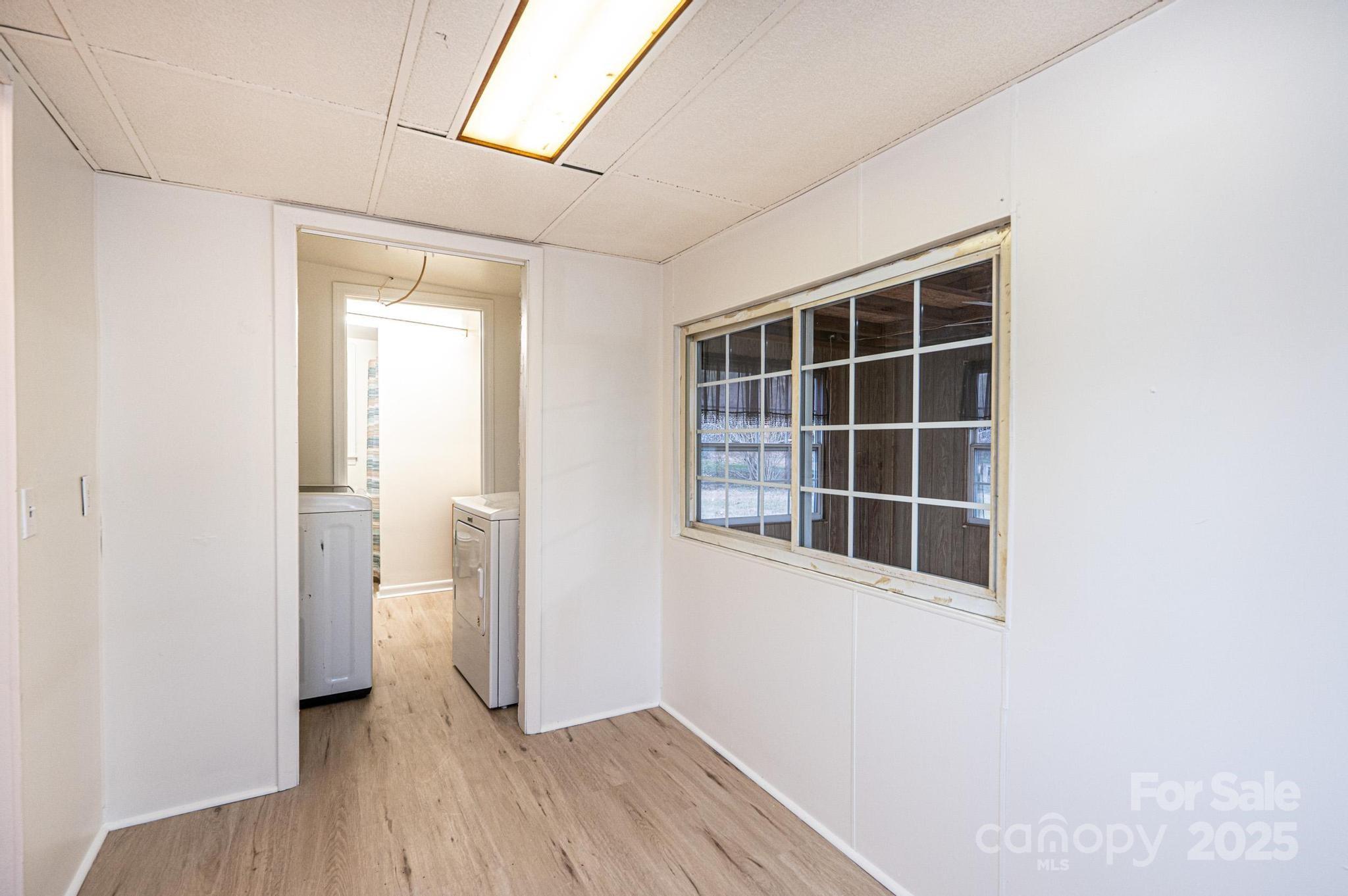 80 Duke Street Granite Falls, NC 28630 - Photo 36 of 48 an empty room with wooden floor and windows