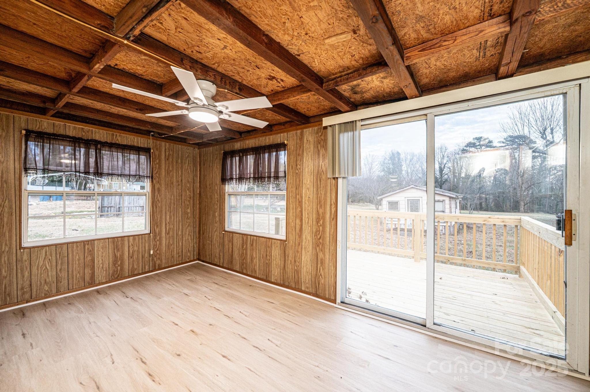 80 Duke Street Granite Falls, NC 28630 - Photo 40 of 48 an empty room with wooden floor and windows