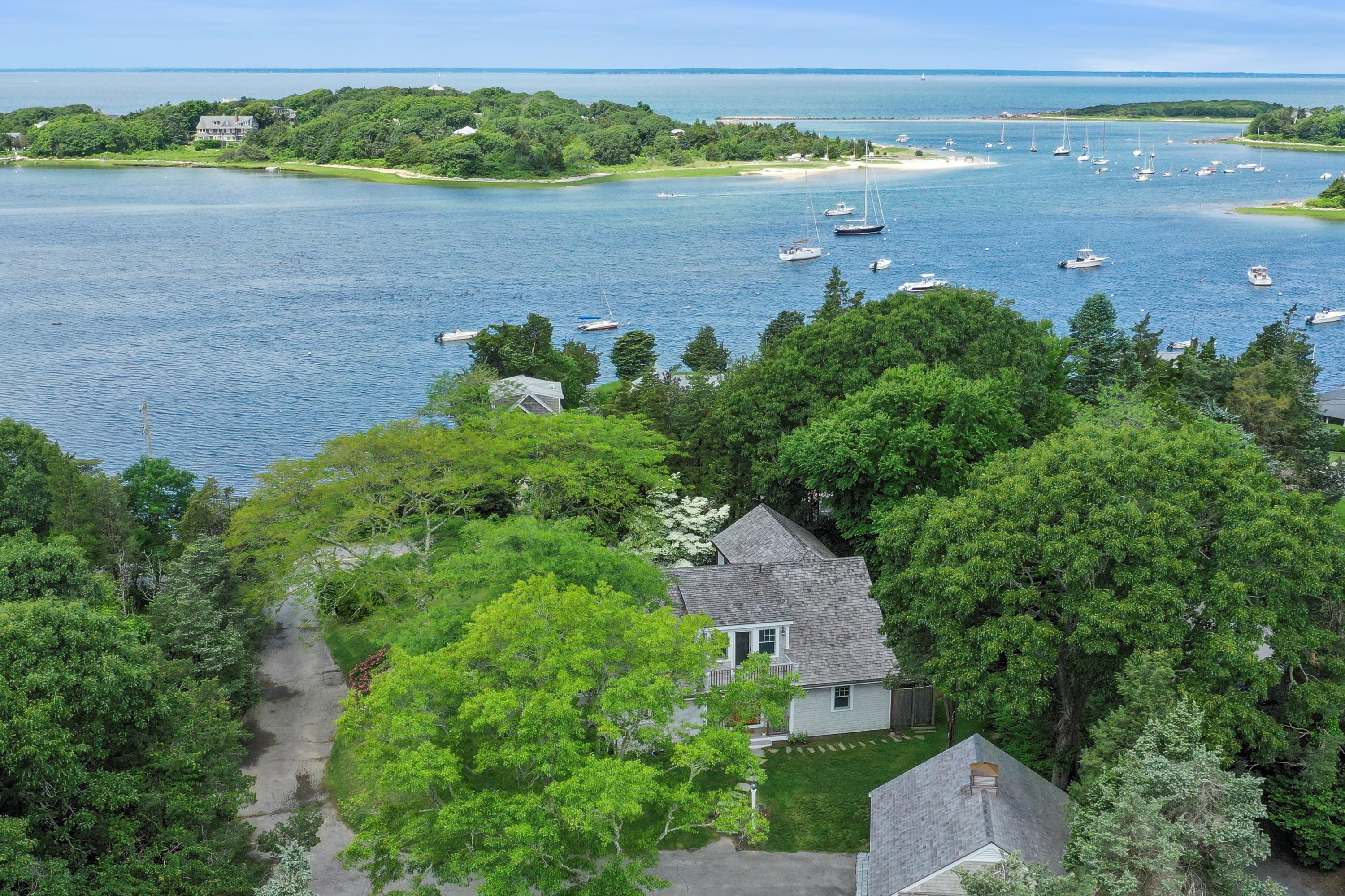 an aerial view of a house with a yard and lake view