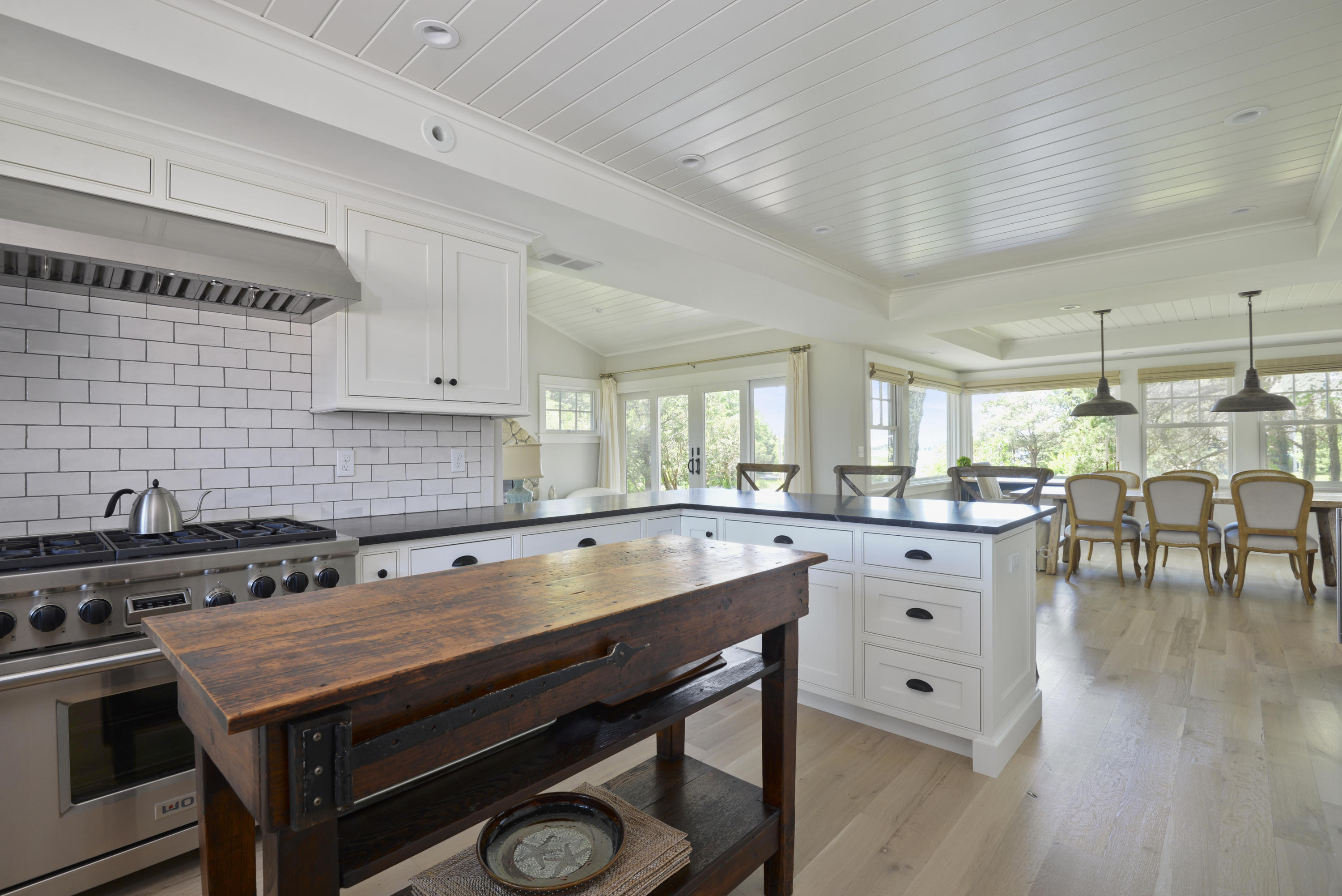 84 Old Dock Road Falmouth, MA 02540 - Photo 13 of 36 a kitchen with a table chairs stove and cabinets