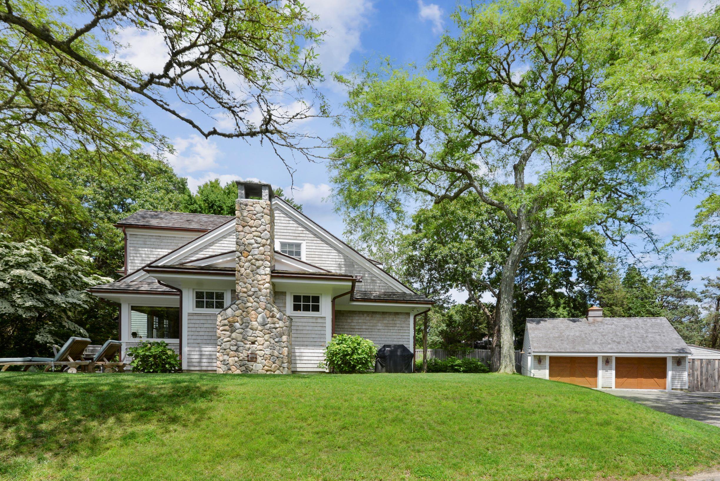 84 Old Dock Road Falmouth, MA 02540 - Photo 6 of 36 a front view of a house with a garden and trees