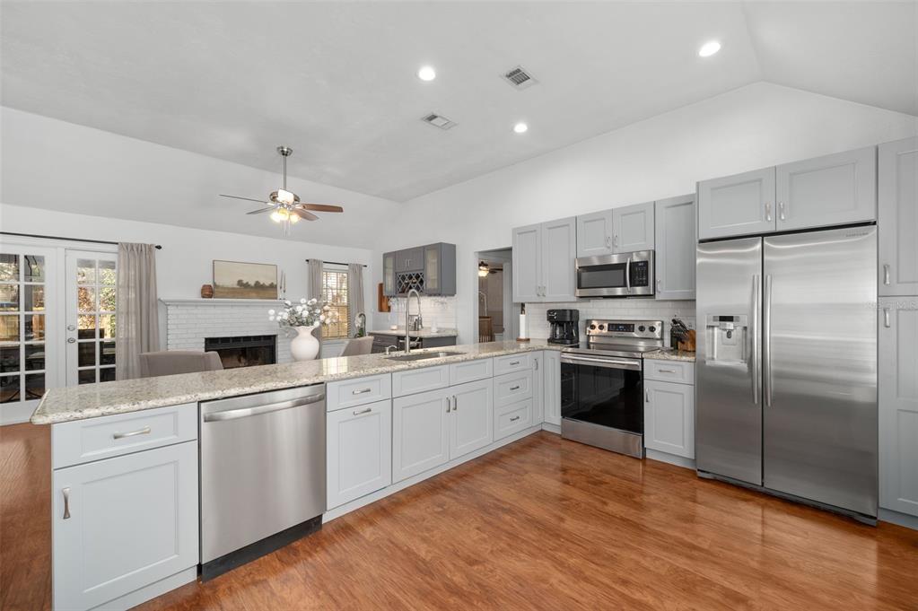 5326 Southwest 83 Terrace Gainesville, FL 32608 - Photo 12 of 40 a large kitchen with cabinets stainless steel appliances and a counter top space