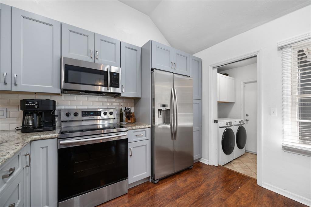 5326 Southwest 83 Terrace Gainesville, FL 32608 - Photo 13 of 40 a kitchen with a refrigerator stove and microwave