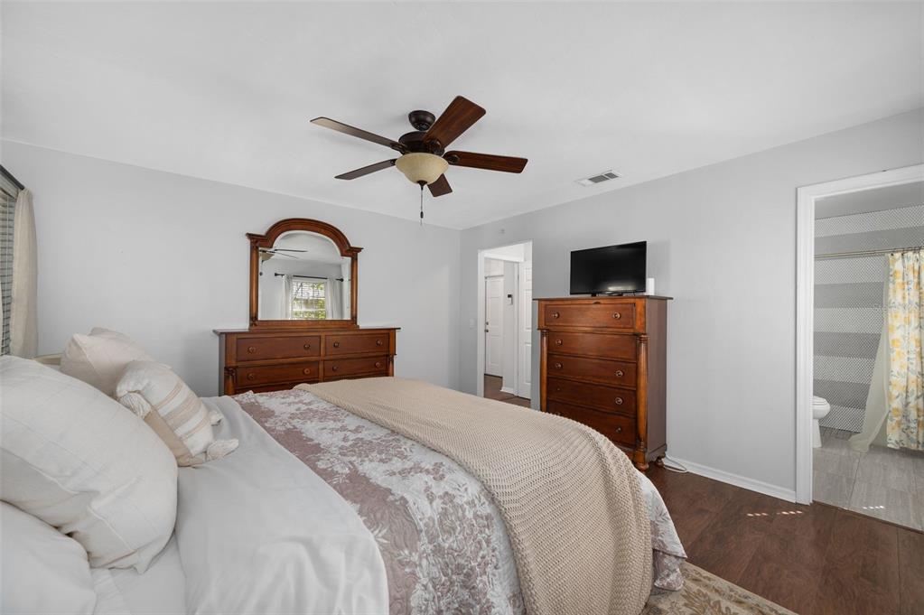 5326 Southwest 83 Terrace Gainesville, FL 32608 - Photo 20 of 40 a bedroom with a bed and a flat screen tv
