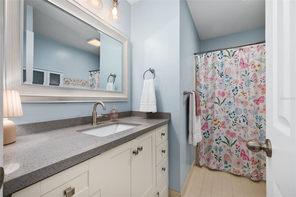 5326 Southwest 83 Terrace Gainesville, FL 32608 - Photo 28 of 40 a bathroom with a granite countertop sink and a mirror