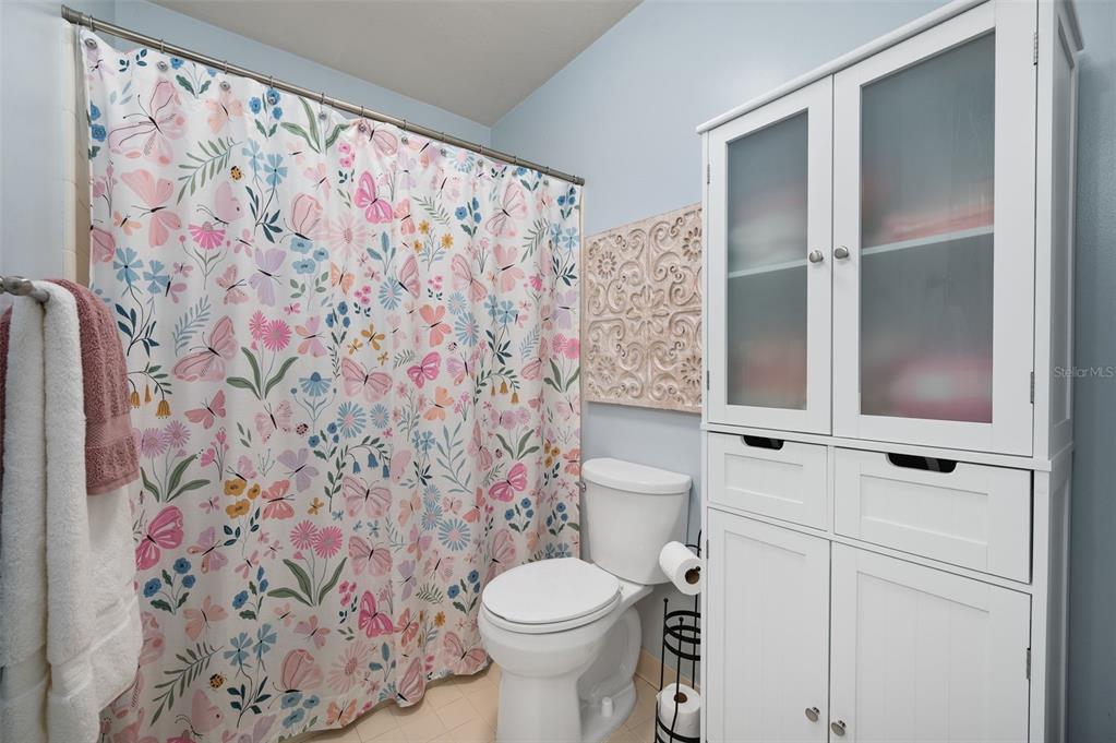 5326 Southwest 83 Terrace Gainesville, FL 32608 - Photo 29 of 40 a white toilet sitting next to a shower curtain