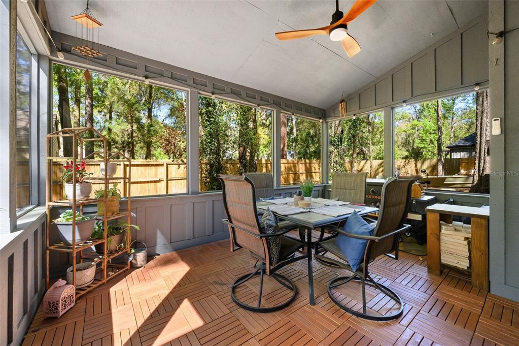 5326 Southwest 83 Terrace Gainesville, FL 32608 - Photo 33 of 40 a workspace with furniture large windows and wooden floor