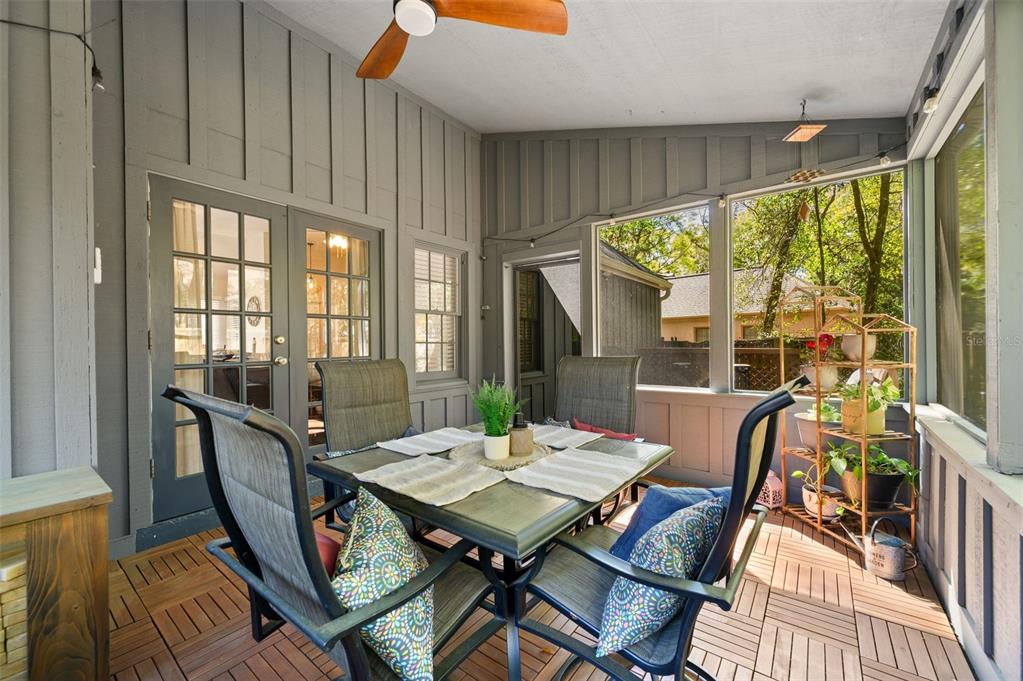 5326 Southwest 83 Terrace Gainesville, FL 32608 - Photo 34 of 40 a view of a dining room with furniture large windows and wooden floor