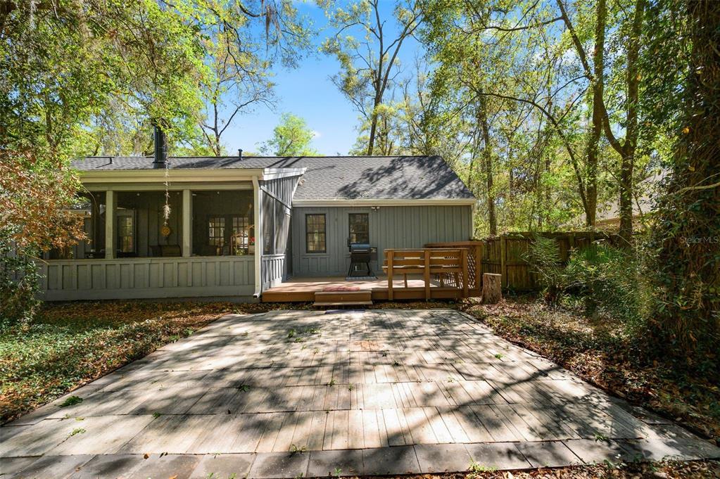 5326 Southwest 83 Terrace Gainesville, FL 32608 - Photo 38 of 40 a view of a house with a large tree and a yard