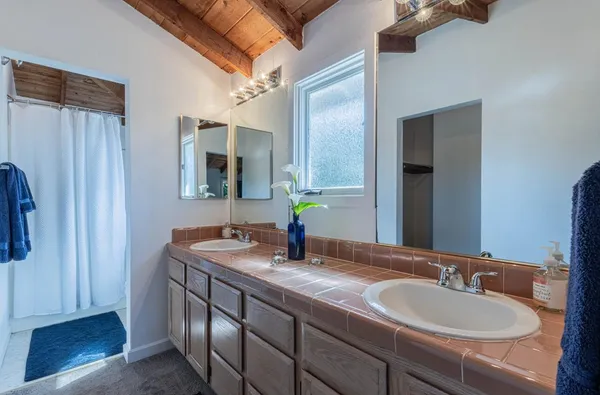 a bathroom with a double vanity sink and a mirror
