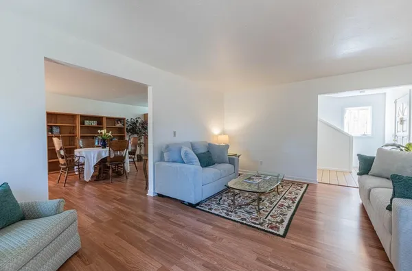 a living room with furniture and wooden floor