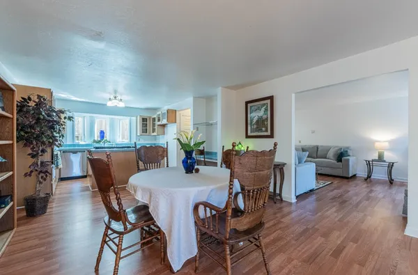 a view of a dining room with furniture and wooden floor