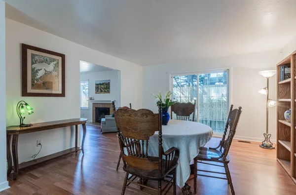 a view of a dining room with furniture and wooden floor