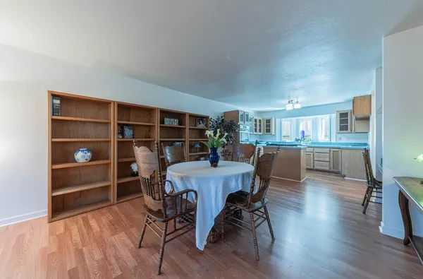 a dining room with furniture and wooden floor