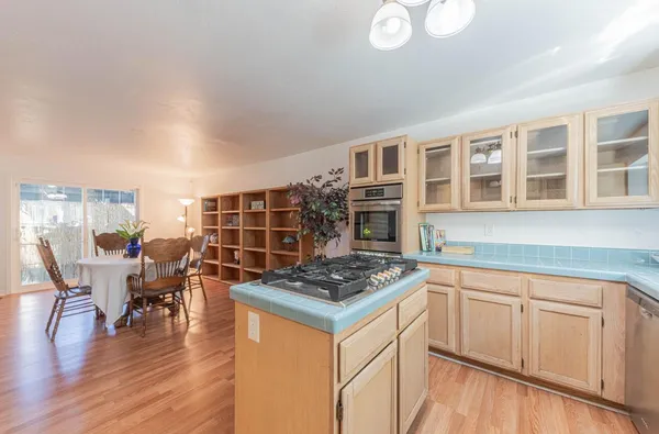 a kitchen that has a table and chairs in it