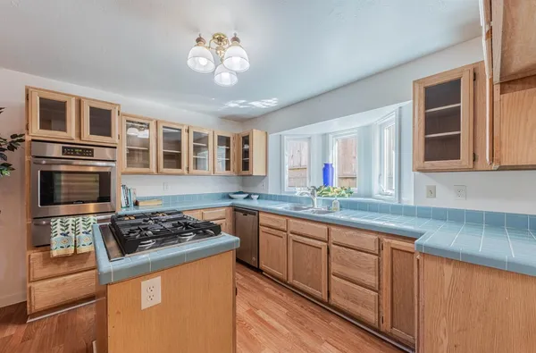 a kitchen with stainless steel appliances granite countertop a stove and a sink