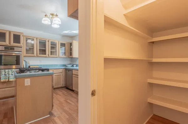 a kitchen with stainless steel appliances granite countertop a sink and a refrigerator