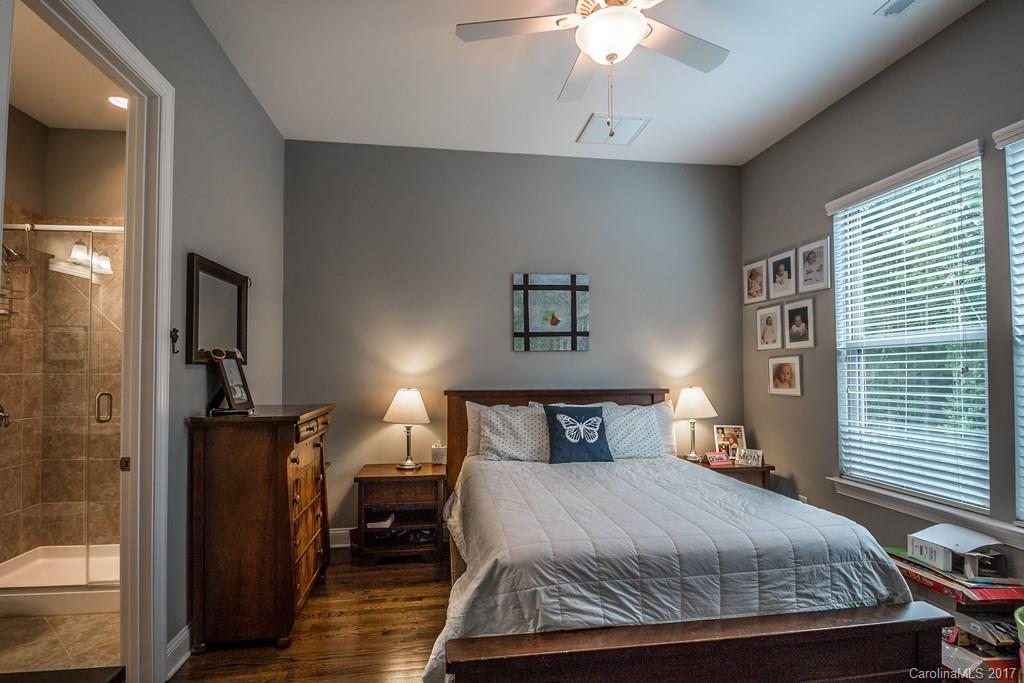 8037 Clems Branch Road, Unit 137 Indian Land, SC 29707 - Photo 11 of 24 a bedroom with a bed and a chandelier