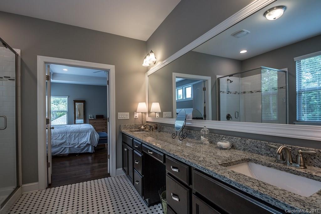 8037 Clems Branch Road, Unit 137 Indian Land, SC 29707 - Photo 15 of 24 a en suite bathroom with a granite countertop sink and a mirror