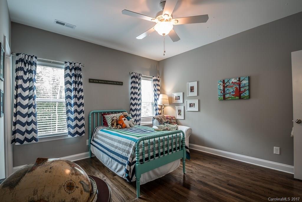 8037 Clems Branch Road, Unit 137 Indian Land, SC 29707 - Photo 17 of 24 a bedroom with a bed and a chandelier