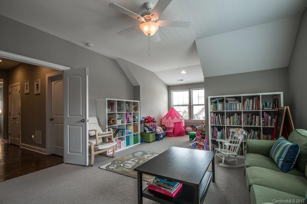 8037 Clems Branch Road, Unit 137 Indian Land, SC 29707 - Photo 19 of 24 a living room with furniture and a bookshelf