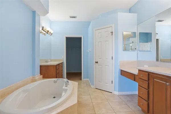 a spacious bathroom with a sink double vanity and a mirror