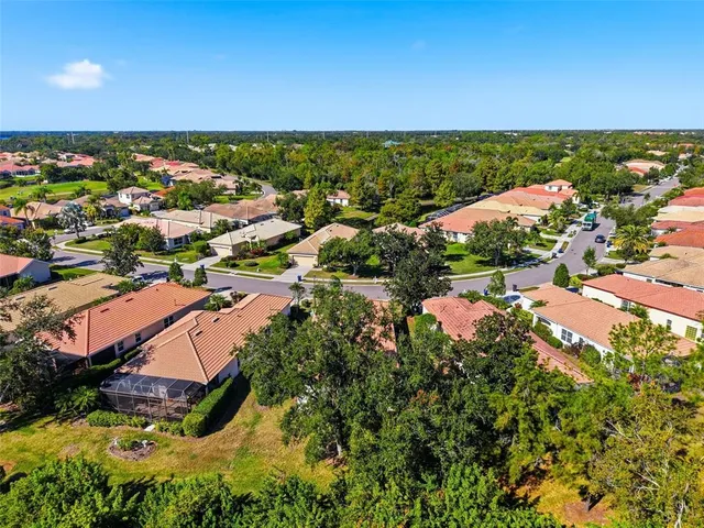an aerial view of a house with a swimming pool yard and outdoor seating