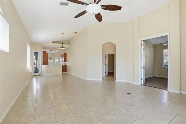 an empty room with closet and windows