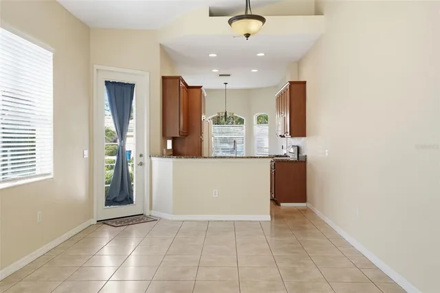 a view of kitchen with kitchen island and stainless steel appliances