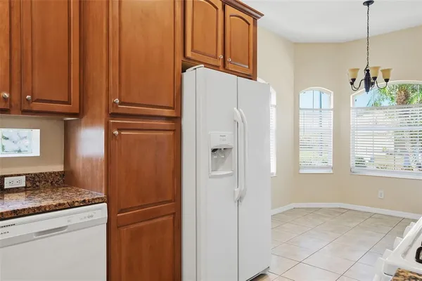 a kitchen with stainless steel appliances granite countertop a refrigerator a microwave and cabinets
