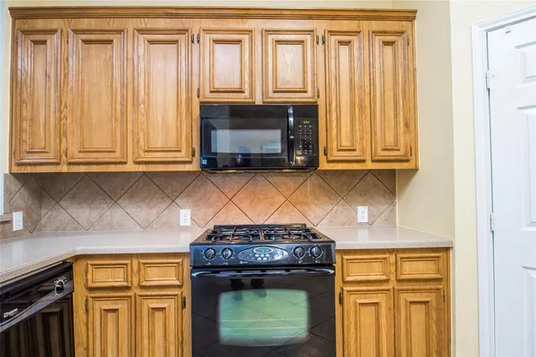 a stove top oven sitting inside of a kitchen