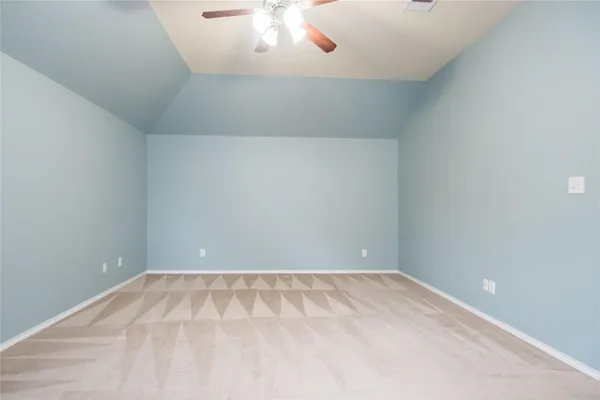 an empty room with a chandelier fan