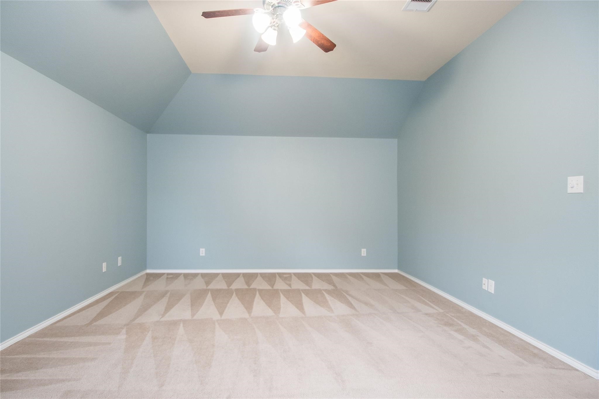 8847 Distant Woods Drive Houston, TX 77095 - Photo 21 of 26 an empty room with a chandelier fan