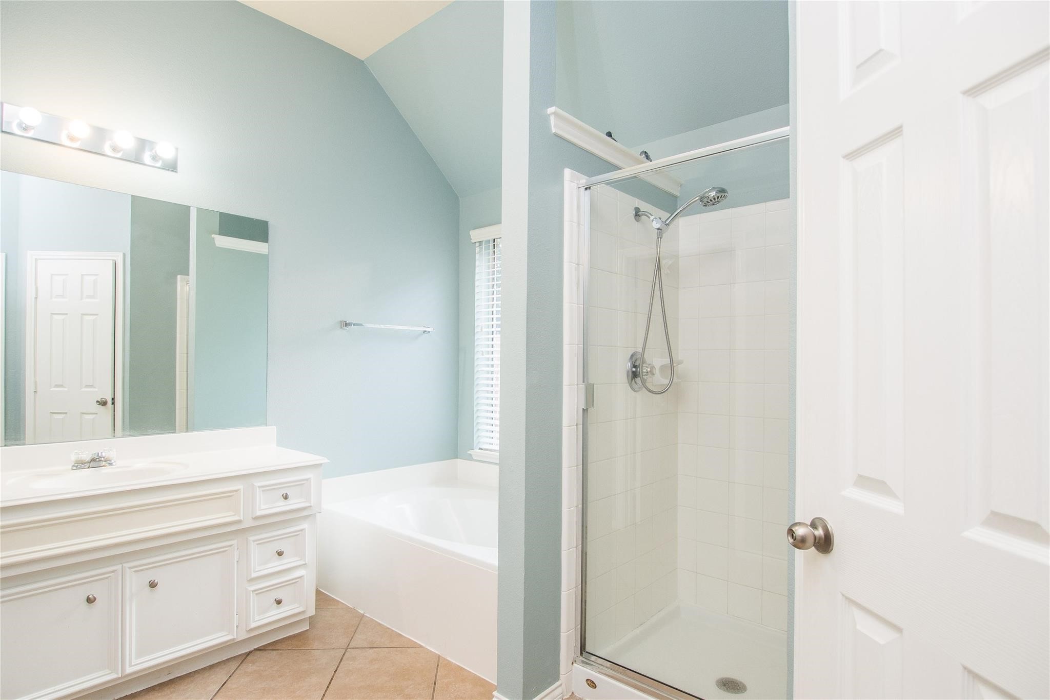 8847 Distant Woods Drive Houston, TX 77095 - Photo 22 of 26 a bathroom with a granite countertop sink a mirror a shower and a bathtub