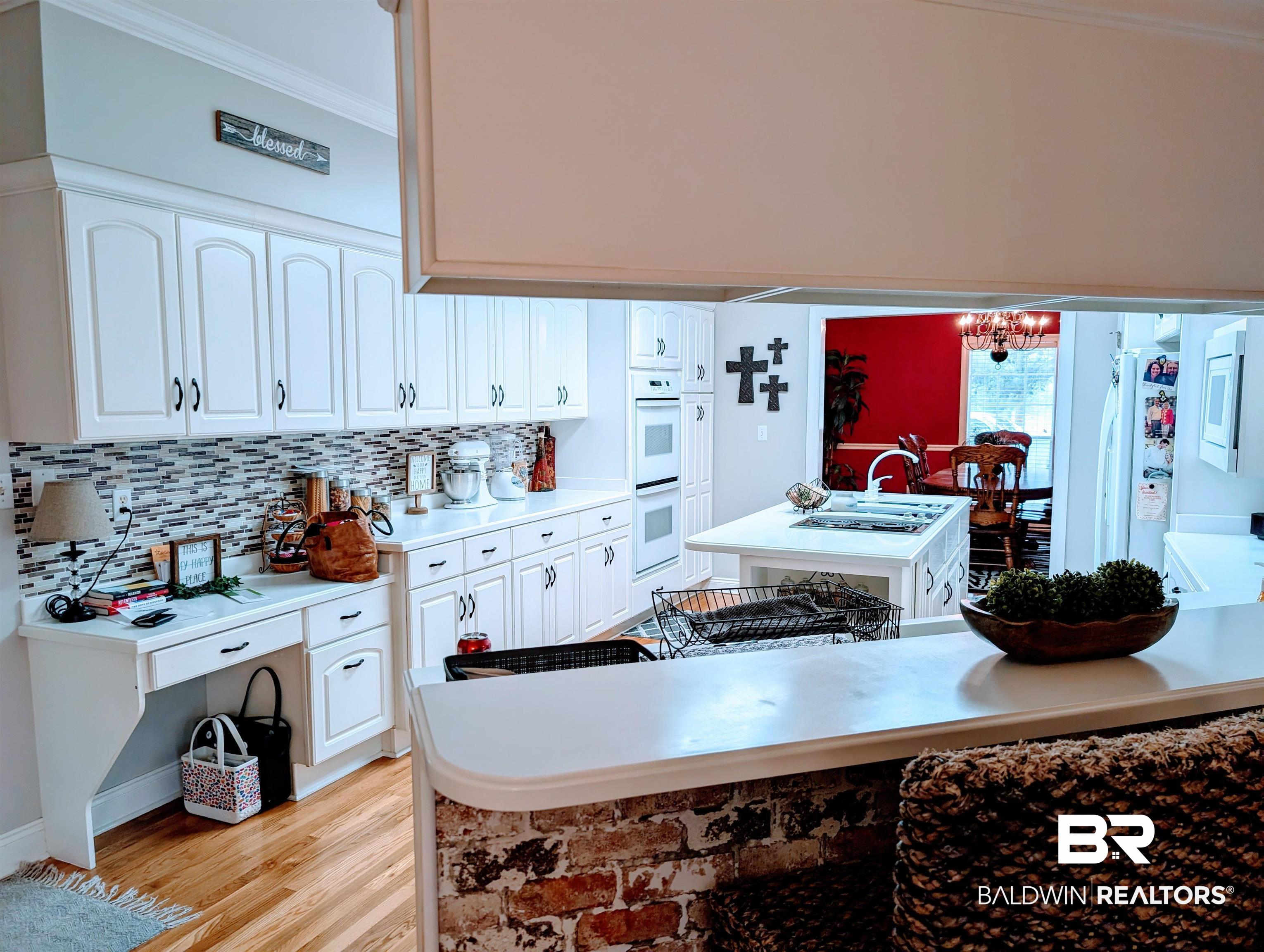 506 Old Castleberry Road Brewton, AL 36426 - Photo 8 of 14 Kitchen featuring white cabinets, light countertops, crown molding, and white appliances