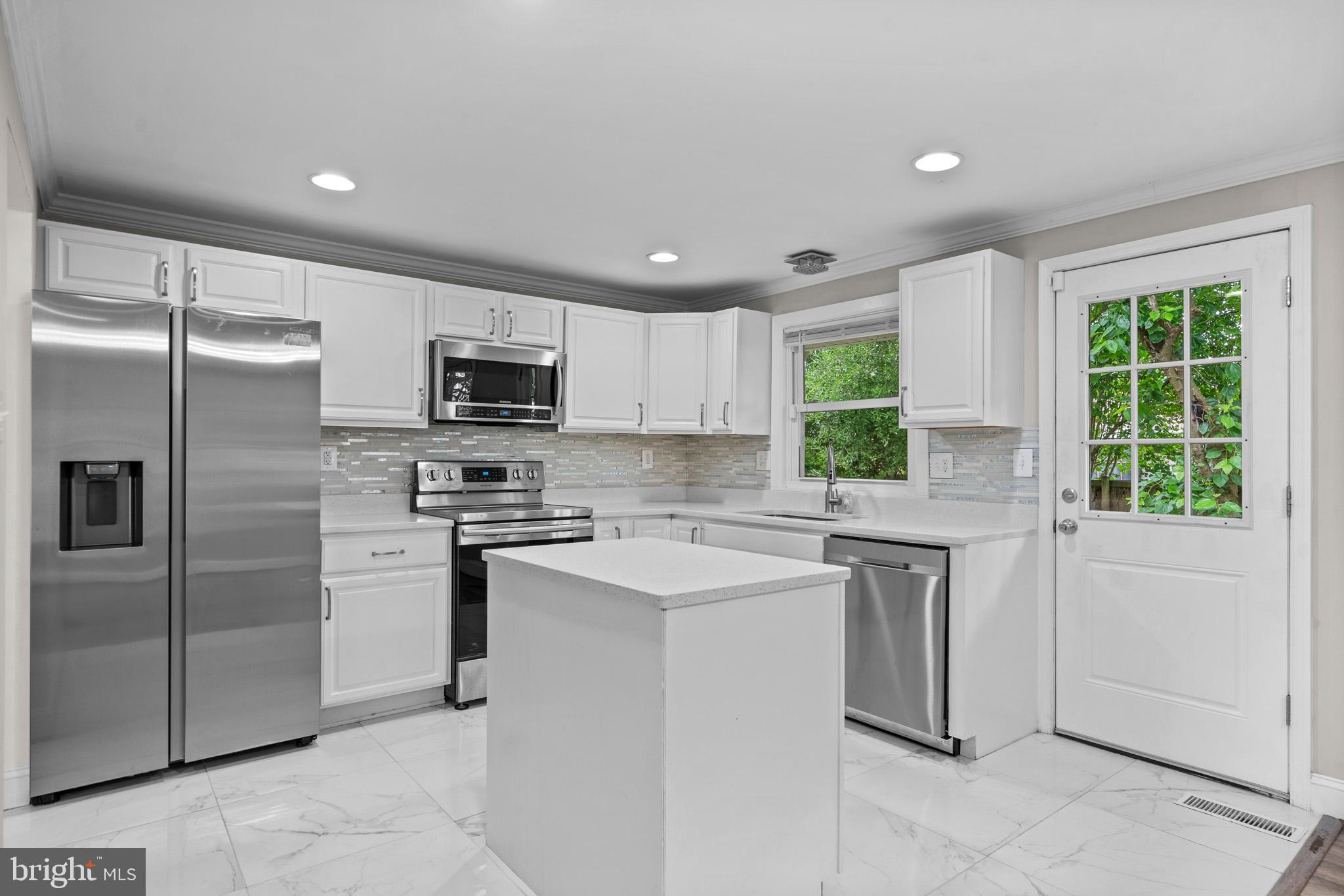 5908 Michael Road Waldorf, MD 20601 - Photo 13 of 44 a kitchen with a refrigerator and a sink