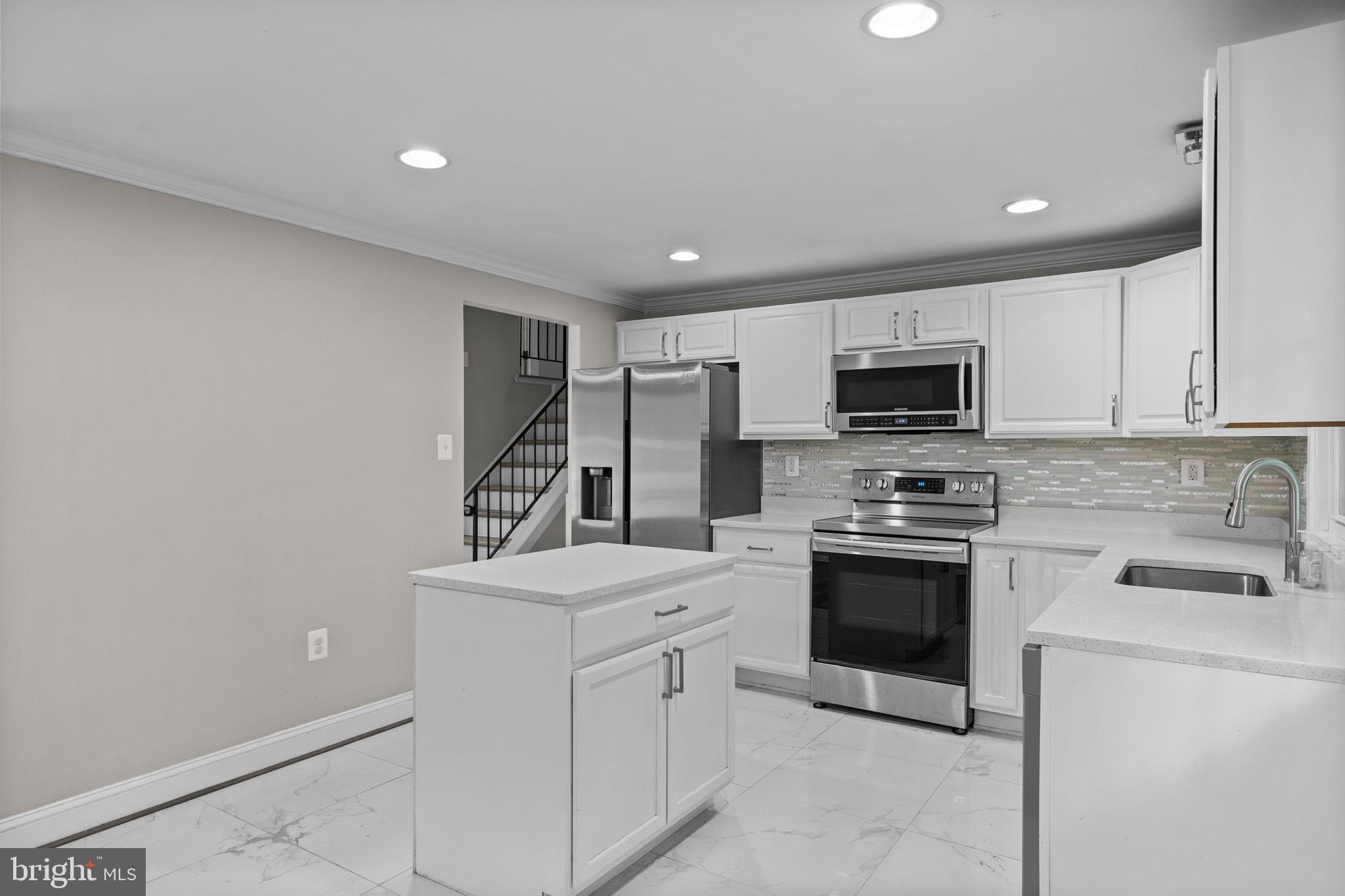 5908 Michael Road Waldorf, MD 20601 - Photo 15 of 44 a kitchen with white cabinets stainless steel appliances and sink